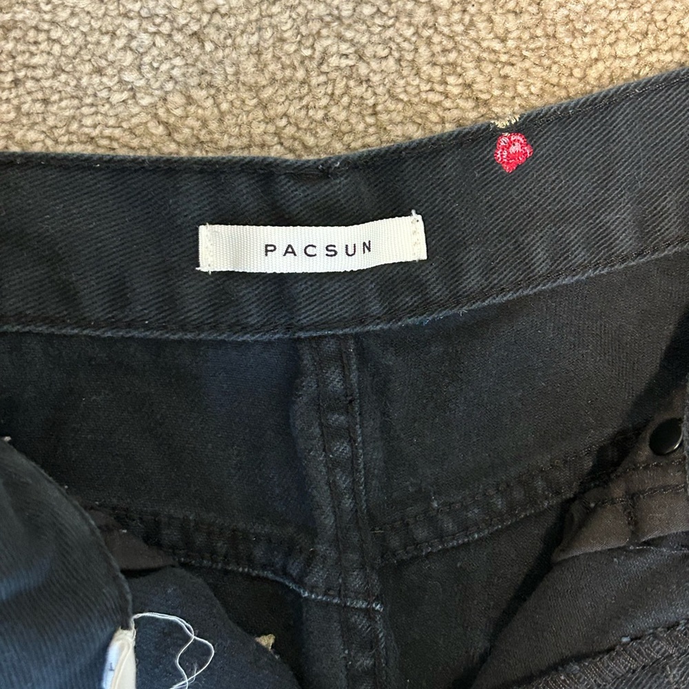 Black high-waisted mom jeans with pink rose embroidery. Lightly worn.
